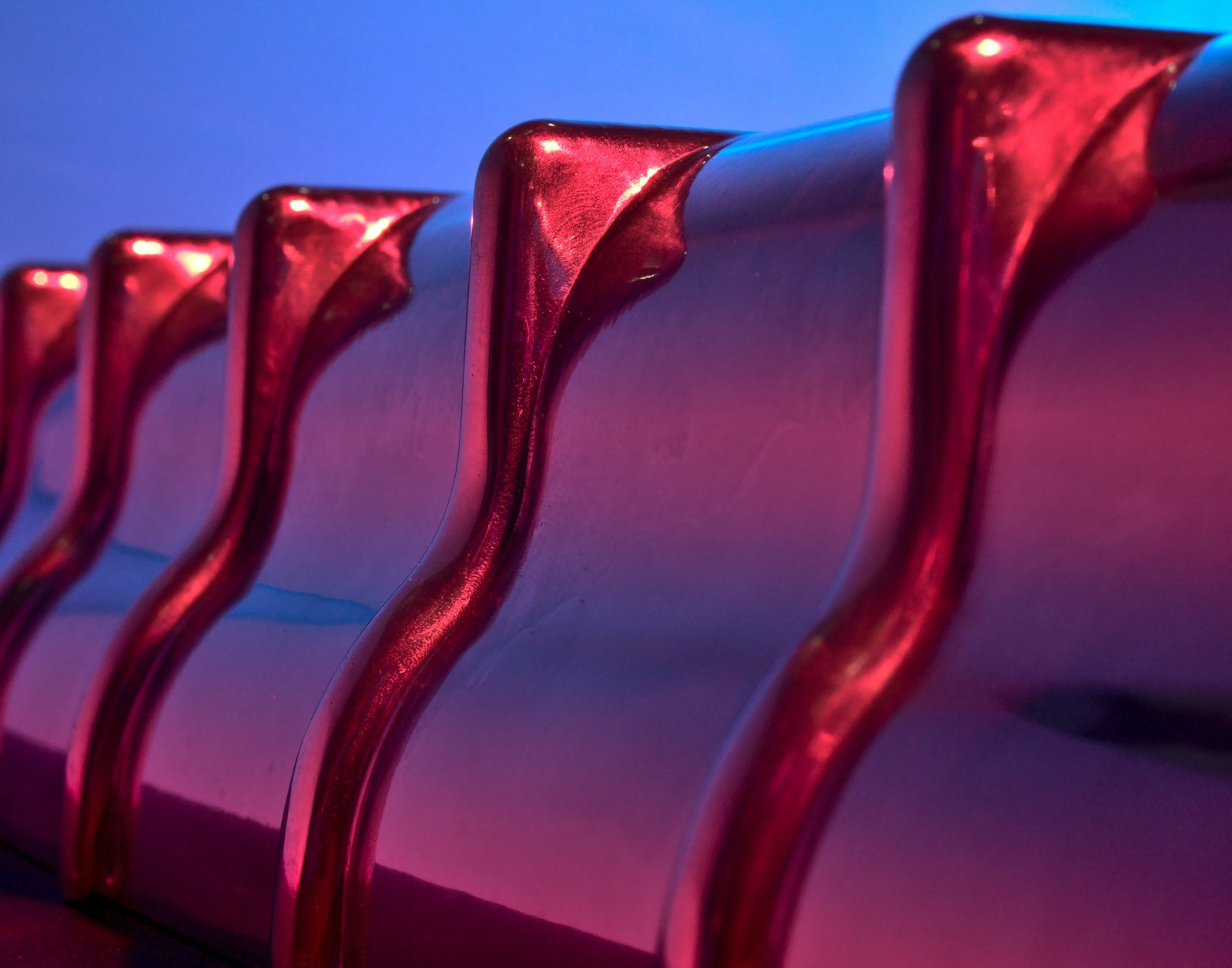 Polished metal fins in violet and cyan